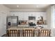 Modern kitchen with white cabinets, granite countertops, and stainless steel appliances at 6429 Alfalfa Ln, Wake Forest, NC 27587