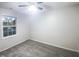 Spacious bedroom with grey carpet and a large window at 4526 Vendue Range Dr, Raleigh, NC 27604