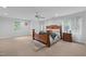 Large main bedroom with wood bed frame and plenty of natural light at 90118 Hoey, Chapel Hill, NC 27517