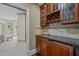 Wet bar with granite countertop, wine rack, and mini-refrigerator at 90118 Hoey, Chapel Hill, NC 27517