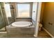 Bathroom with a large soaking tub and separate shower at 1033 Laredo Ln, Durham, NC 27703