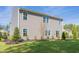 Gray house exterior showcasing a backyard and landscaping at 316 Leven Dr, Gibsonville, NC 27249
