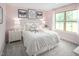 Charming bedroom with a queen-size bed and light pink walls at 8837 Tartan Clan Dr, Willow Springs, NC 27592