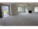 Open living room with grey carpet, fireplace, and high ceiling at 378 Magnolia Run Way, Benson, NC 27504