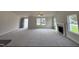 Large living room with grey carpet, fireplace, and high ceiling at 378 Magnolia Run Way, Benson, NC 27504