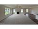 Living room with grey carpet, hardwood floors, and fireplace at 378 Magnolia Run Way, Benson, NC 27504