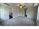 Main bedroom with carpet, ceiling fan, and access to bathroom and closets at 378 Magnolia Run Way, Benson, NC 27504
