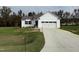 White house exterior with a two-car garage and driveway at 378 Magnolia Run Way, Benson, NC 27504