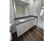Double vanity bathroom with granite countertops and a large mirror at 378 Magnolia Run Way, Benson, NC 27504