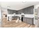 Updated kitchen with gray cabinets, white backsplash and wood flooring at 234 Crumpler Rd, Kenly, NC 27542