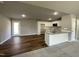 Open kitchen with white cabinets, granite countertops, and a breakfast bar at 79 Tulipfield Way, Benson, NC 27504