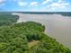 Aerial view of waterfront property with lush trees and lake access at 017 Bartley Holleman Rd # 17, New Hill, NC 27562