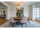 Elegant dining room with round table, chandelier, and built-in wine storage at 013 Bartley Holleman Rd # 13, New Hill, NC 27562