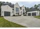 Modern house with white brick, black accents, and three car garage at 013 Bartley Holleman Rd # 13, New Hill, NC 27562