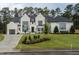 Two story home with white brick, black roof, and landscaping at 013 Bartley Holleman Rd # 13, New Hill, NC 27562