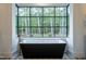 Relaxing bathroom with a freestanding soaking tub and large window at 013 Bartley Holleman Rd # 13, New Hill, NC 27562