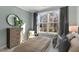 Bright bedroom with large window, plush bed, and ample natural light at 734 Apple Churn Dr, Fuquay Varina, NC 27526