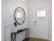 Bright and airy entryway featuring a large round mirror and console table at 734 Apple Churn Dr, Fuquay Varina, NC 27526