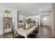 Open dining room with a farmhouse style table and chairs, adjacent to the kitchen at 734 Apple Churn Dr, Fuquay Varina, NC 27526