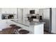 Modern kitchen with gray countertops, white cabinets, and stainless steel appliances at 734 Apple Churn Dr, Fuquay Varina, NC 27526