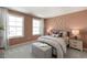 Cozy bedroom with butterfly wall art, ample natural light, and stylish decor at 730 Apple Churn Dr, Fuquay Varina, NC 27526