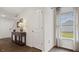 Bright foyer with hardwood floors, a console table, and a coat closet at 1915 Puffin Dr # 198, Haw River, NC 27258