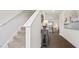 Modern staircase with carpeted steps and white railings leading to the upper level at 1915 Puffin Dr # 198, Haw River, NC 27258