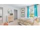 Well-lit bedroom with teal curtains and patterned bedding at 1915 Puffin Dr # 198, Haw River, NC 27258