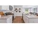 Modern kitchen with white cabinets, granite countertops, and stainless steel appliances at 1915 Puffin Dr # 198, Haw River, NC 27258