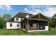 Back view of a home showcasing a large covered patio with outdoor kitchen at 5025 Quail Hollow Dr, Raleigh, NC 27609