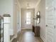 Bright entryway with hardwood floors, a console table, and access to stairs at 101 Asti Ct, Clayton, NC 27527