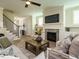 Cozy living room with fireplace, built-in shelving and large windows at 101 Asti Ct, Clayton, NC 27527