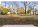 Spacious backyard with mature trees and a partially fenced area at 329 & 331 Roxboro St, Haw River, NC 27258