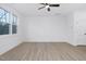 Simple bedroom with hardwood floors and a large window at 329 & 331 Roxboro St, Haw River, NC 27258