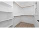 Spacious walk-in closet with built-in shelves and hanging rods at 329 & 331 Roxboro St, Haw River, NC 27258