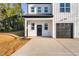 Modern farmhouse style home with black garage door and front entry at 329 & 331 Roxboro St, Haw River, NC 27258