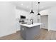 Modern kitchen with white cabinets and a gray island at 329 & 331 Roxboro St, Haw River, NC 27258
