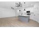Modern kitchen with gray island and white cabinets at 329 & 331 Roxboro St, Haw River, NC 27258