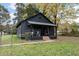 Dark gray house with a covered porch and landscaping at 617 Orange Heights Loop Rd, Hillsborough, NC 27278