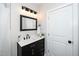 Stylish bathroom with a dark vanity and a white quartz countertop at 617 Orange Heights Loop Rd, Hillsborough, NC 27278