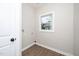 Bright laundry room with vinyl flooring and a window at 617 Orange Heights Loop Rd, Hillsborough, NC 27278