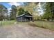 Dark gray house exterior with gravel driveway at 617 Orange Heights Loop Rd, Hillsborough, NC 27278