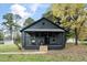 Dark gray house with a covered porch and landscaping at 617 Orange Heights Loop Rd, Hillsborough, NC 27278