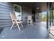 Covered porch with wooden chairs and fall leaves at 617 Orange Heights Loop Rd, Hillsborough, NC 27278