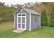Gray storage shed with white trim and ramp at 30 Willow Bend Dr, Youngsville, NC 27596