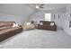 Bright bonus room with two couches and ceiling fan at 30 Willow Bend Dr, Youngsville, NC 27596