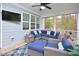 Screened porch with sectional sofa and flat-screen TV at 30 Willow Bend Dr, Youngsville, NC 27596