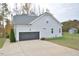 Two-car garage with a spacious driveway and shed in the backyard at 30 Willow Bend Dr, Youngsville, NC 27596