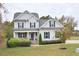 Two-story home with gray siding, brick accents, and a welcoming front porch at 30 Willow Bend Dr, Youngsville, NC 27596