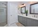 Double vanity bathroom with gray cabinets and a walk-in shower at 30 Willow Bend Dr, Youngsville, NC 27596